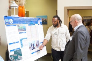 A student presents his research during the poster session.